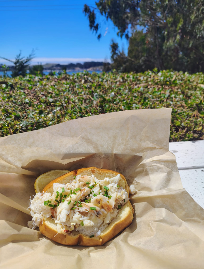 Dungeness crab roll with chives, with Bodega Bay in the background